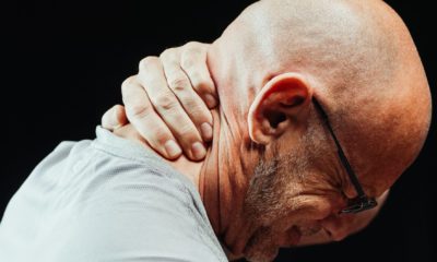 close up photo of a man having a neck pain