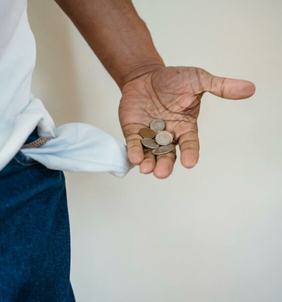 close up of man holding coins in hand